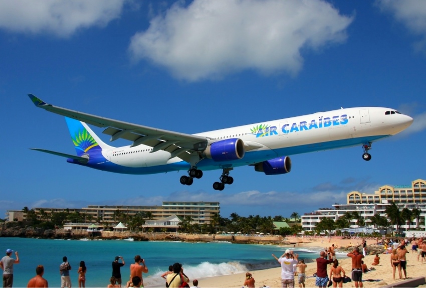 Airplane landing over the beach